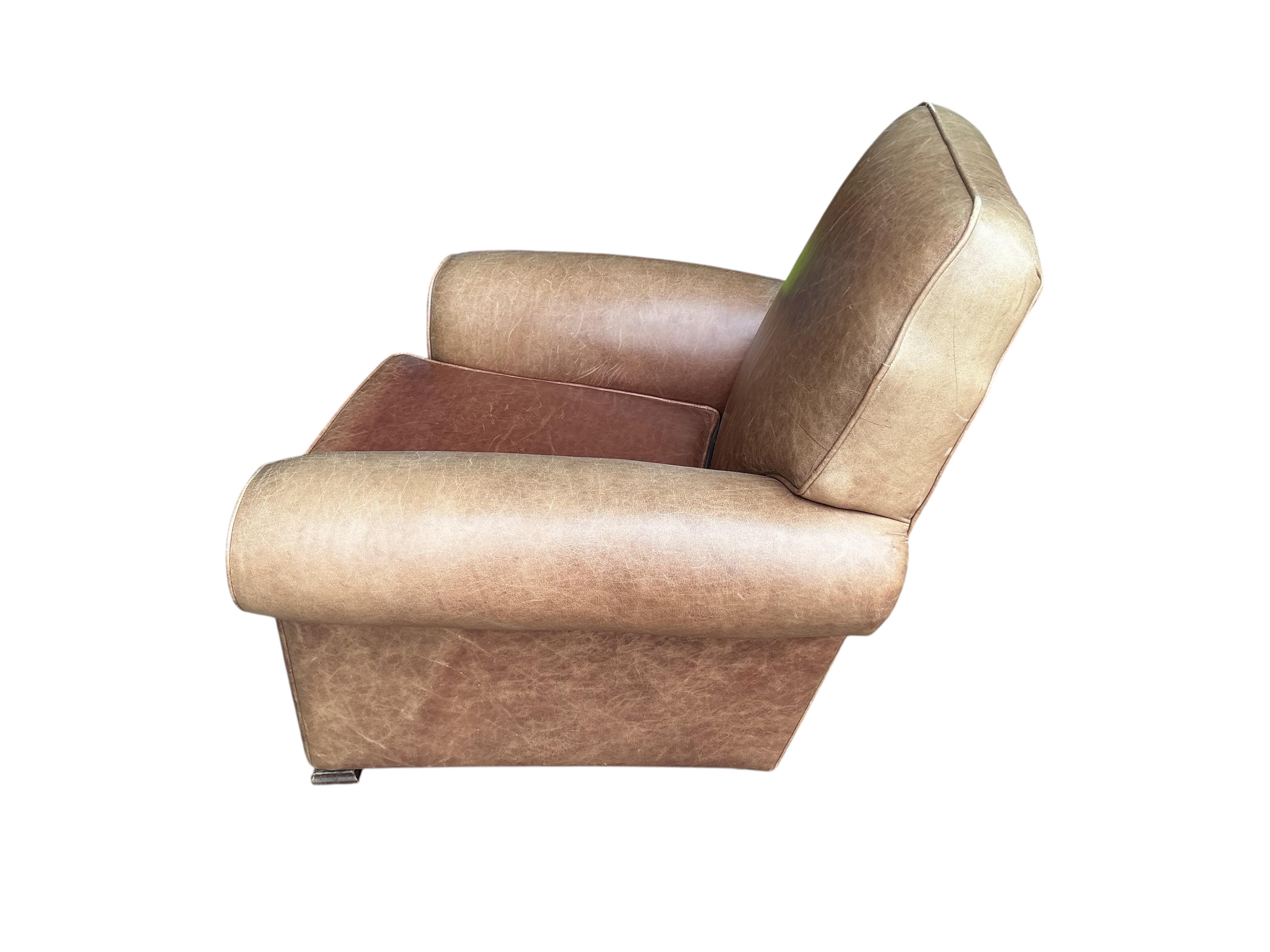 A pair of early 20th century tan leather club chairs, width 94cm, depth 78cm, height 80cm